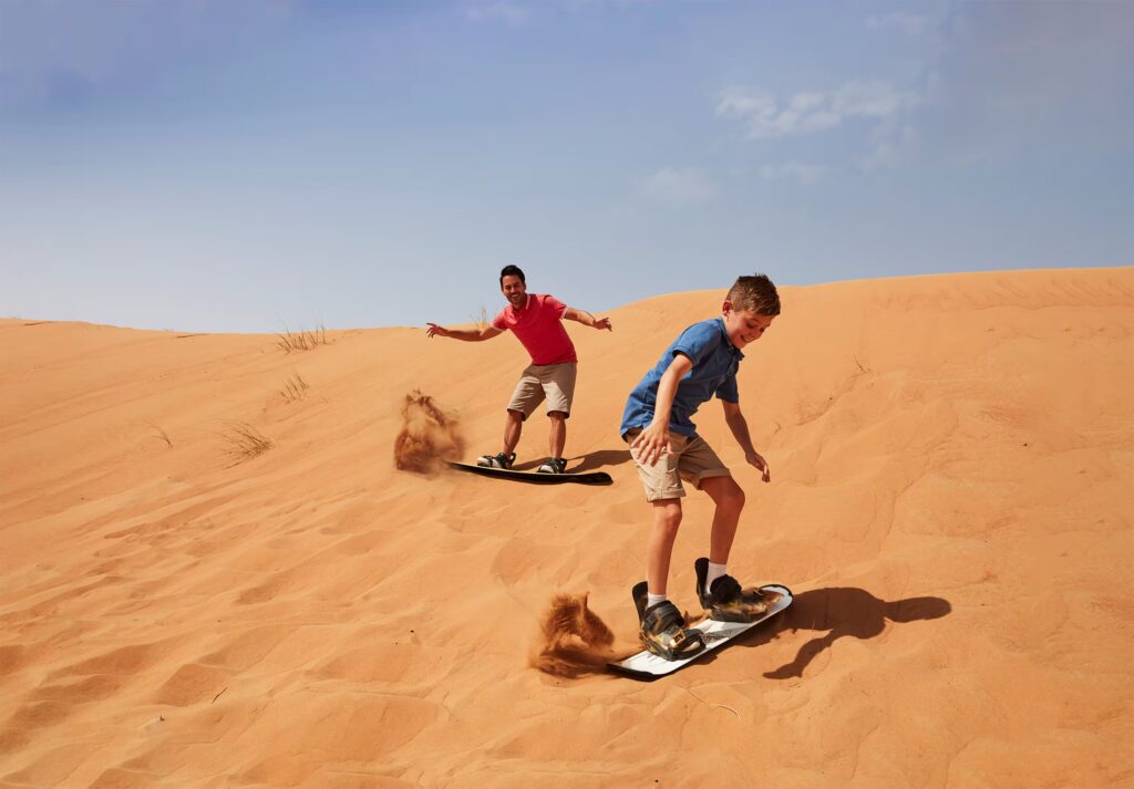 Sandboarding on desert dunes